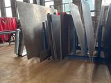 several pieces of metal are stacked on top of each other in a room