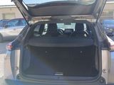 the back of a car with its trunk open in a parking lot