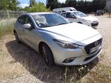 a silver mazda car parked in a lot with other cars in the background