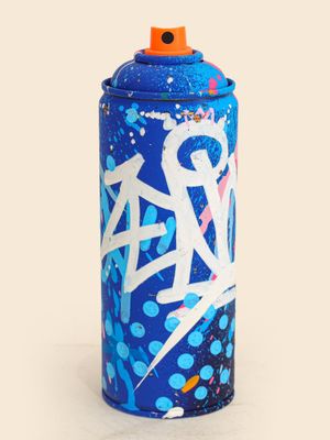 graffiti spray can on a white surface with a blue background