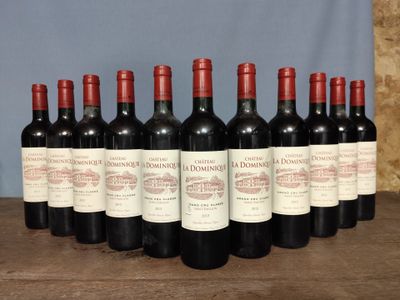 six bottles of red wine are lined up on a wooden table
