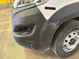 a close up of a car ' s front bumper with a denting on it