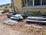 many pieces of metal sitting on the ground outside of a house