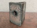 a small box with a hole in it sitting on a table