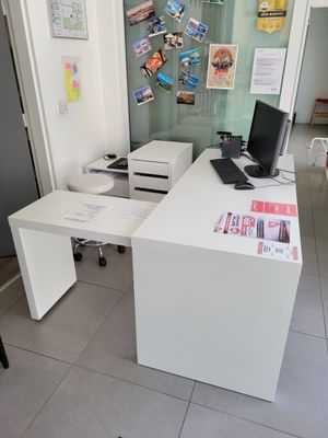 a white desk with a computer on it in a room