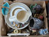 a box full of assorted items including a cup and saucer