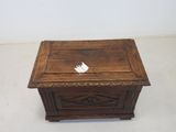 an old wooden box with a paper bird on top