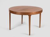une table ronde avec deux pieds et un plateau en bois