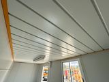 a white room with a window and a white ceiling