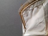 a close up of a white purse with pearls on it