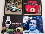 three books on a table with a picture of a race car and a number of other books