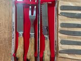 three knives and a knife sharper in a box on a table