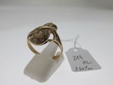 une image d'une bague en or sur une surface blanche avec une étiquette de prix