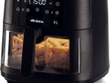 an air fryer with french fries in it on a white surface