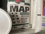 several bags of cement sit on top of a shelf next to a barrel