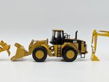 four toy construction vehicles that are lined up on a white surface