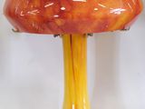 a red and yellow mushroom shaped lamp on a table