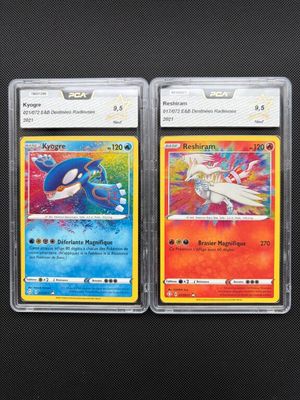 two pokemon cards are sitting side by side on a black surface