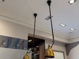 three lights that are hanging from the ceiling in this kitchen