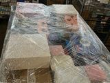 many boxes of items wrapped in plastic on a table