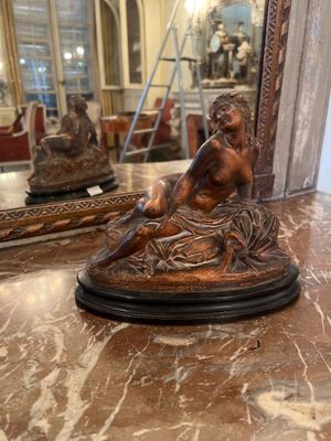 a statue of a man sitting on a marble table