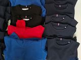 a lot of t - shirts laid out on a table