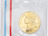 a close up of a coin in a plastic bag on a white surface