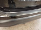 a close up of the bumper of a car with a denting on it