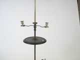 a candle holder with two candles on it on a table