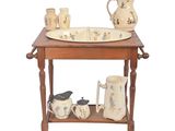 a wooden table with a bowl, pitcher, and cups on it