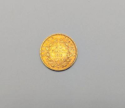a close up of a gold coin on a gray surface