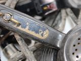 a close up of an old sewing machine on a pile of other items