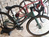 three bikes that are sitting on a stand next to each other