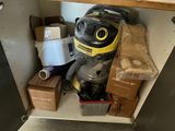 a vacuum that is sitting on a shelf in a cabinet
