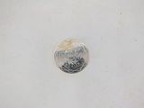 a close up of a coin on a white surface with a white background