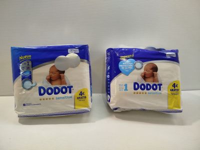 two packs of baby diapers sitting next to each other on a table