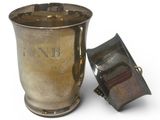 a silver cup with a lid sitting next to a lighter