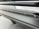 a close up of a car ' s bumper with holes in it