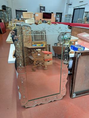 a large mirror sitting on the floor in a room