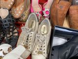 many pairs of shoes in a box on the floor