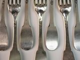 a lot of forks and spoons that are on the table