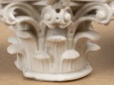 a close up of a white vase with flowers on it