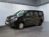 the black van is parked in a large room with white walls