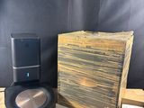 an image of a speaker and a box on a table
