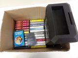 a cardboard box filled with dvds and a remote control