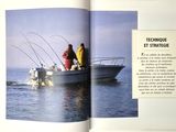 two men on a boat in the water with fishing rods