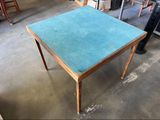 une table recouverte d'une nappe bleue, au milieu d'une pièce