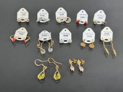 a lot of earrings that are sitting on a table