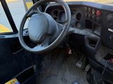 a view of the inside of a truck from the driver ' s seat