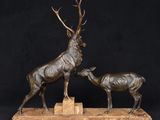 bronze sculpture of a stag and a baby stag on a marble base